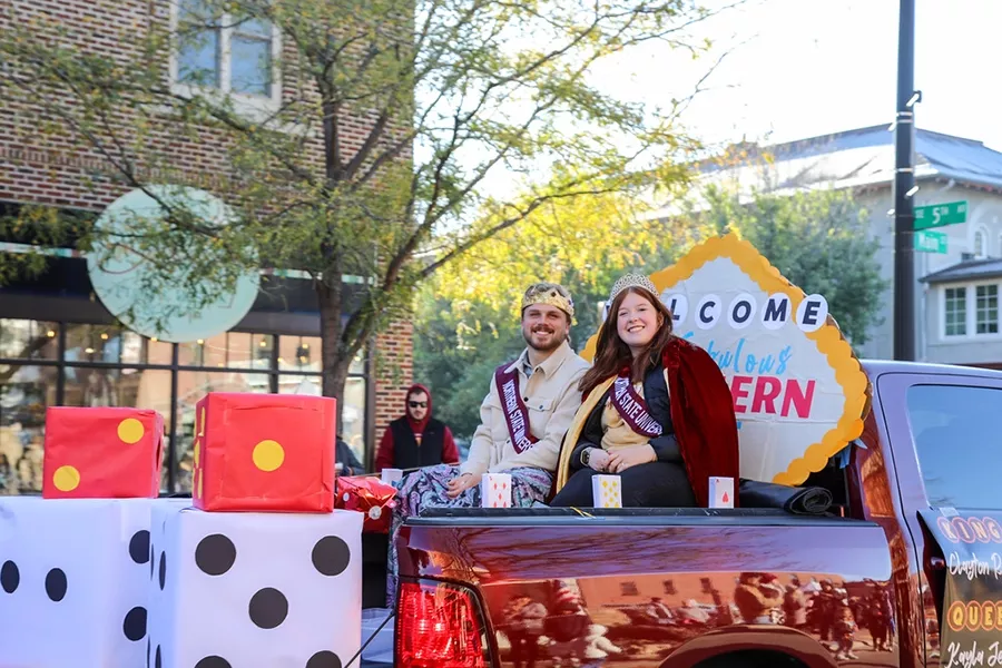 Homecoming royalty ride in a parade float